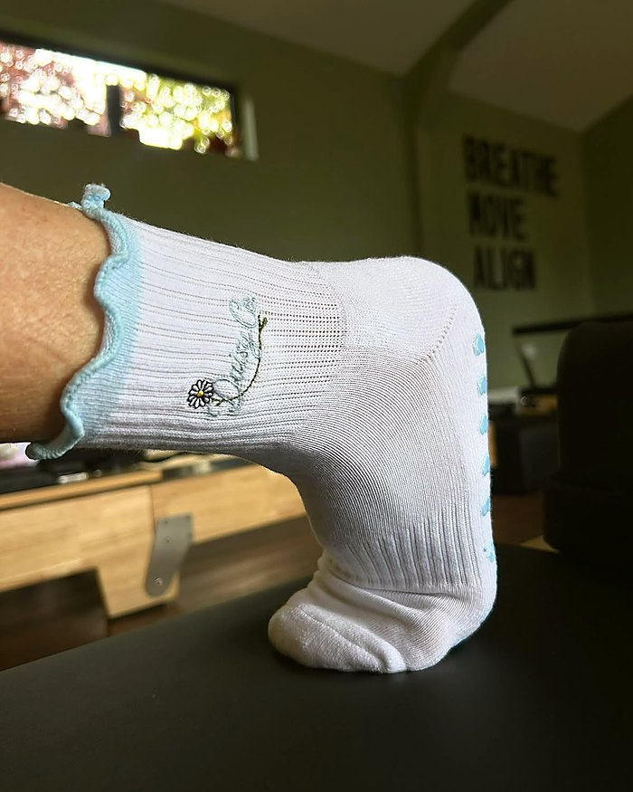 Bluebell Pilates grip socks worn in a reformer studio