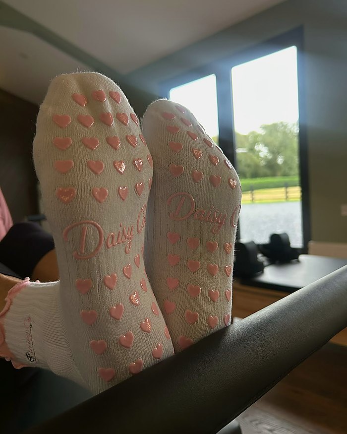 Pink Blossom Pilates grip socks, the silicone heart grip sole in use
