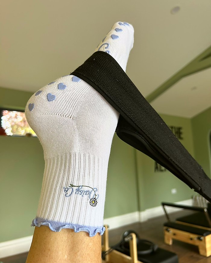 Lilac Dream Pilates grip socks worn in a reformer studio