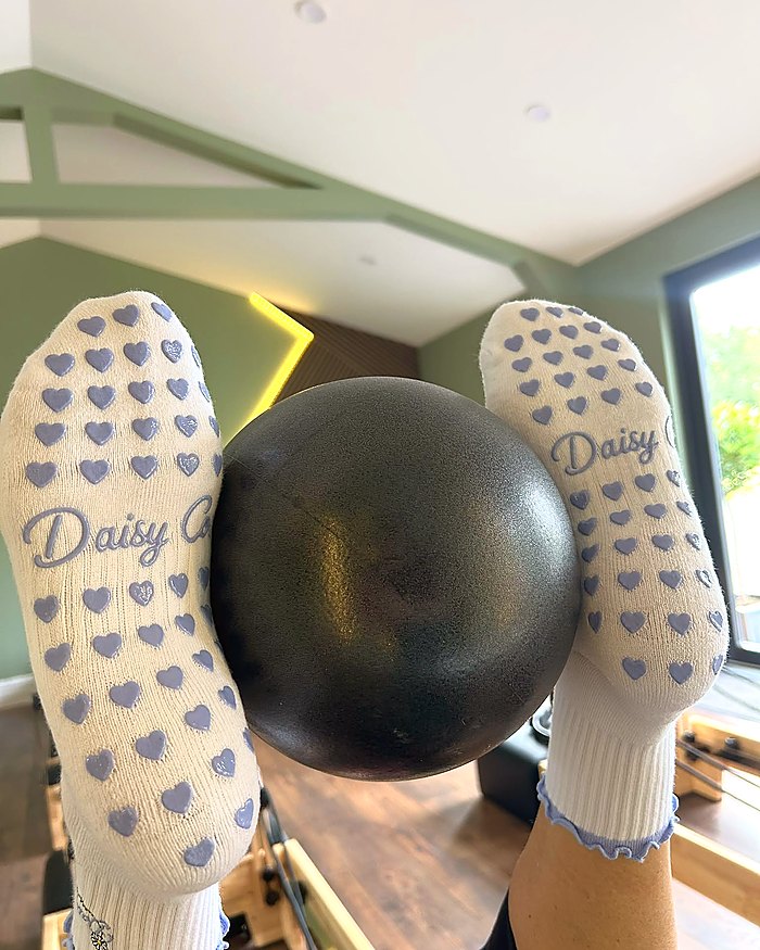 Lilac Dream Pilates grip socks, the silicone heart grip sole in use