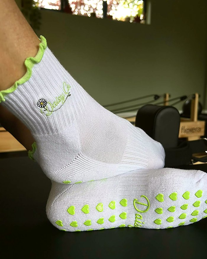 Fresh Meadow Pilates grip socks worn in a reformer studio