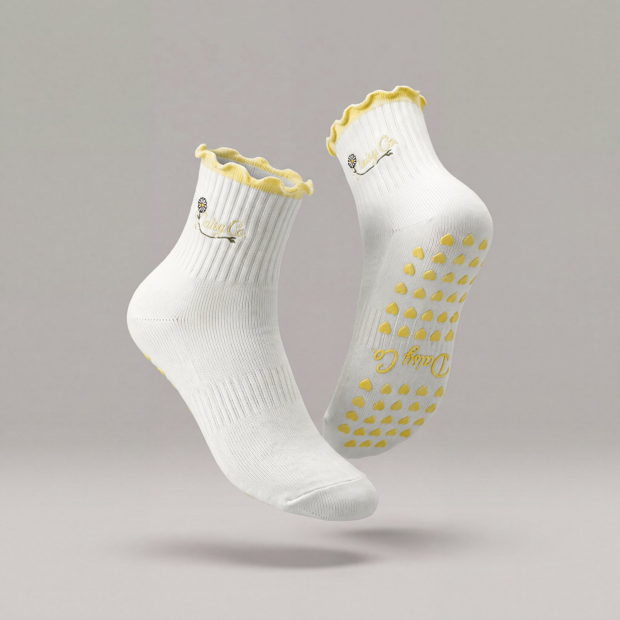 Limoncello pilates grip socks by Daisy Co., soft yellow frill cuff and silicone heart grip sole