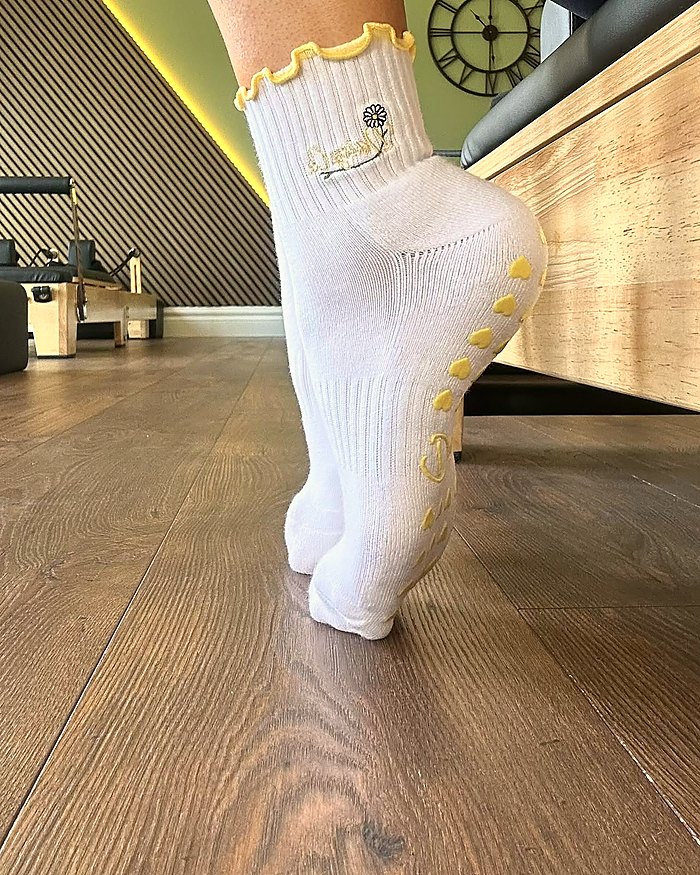 Limoncello Pilates grip socks worn in a reformer studio