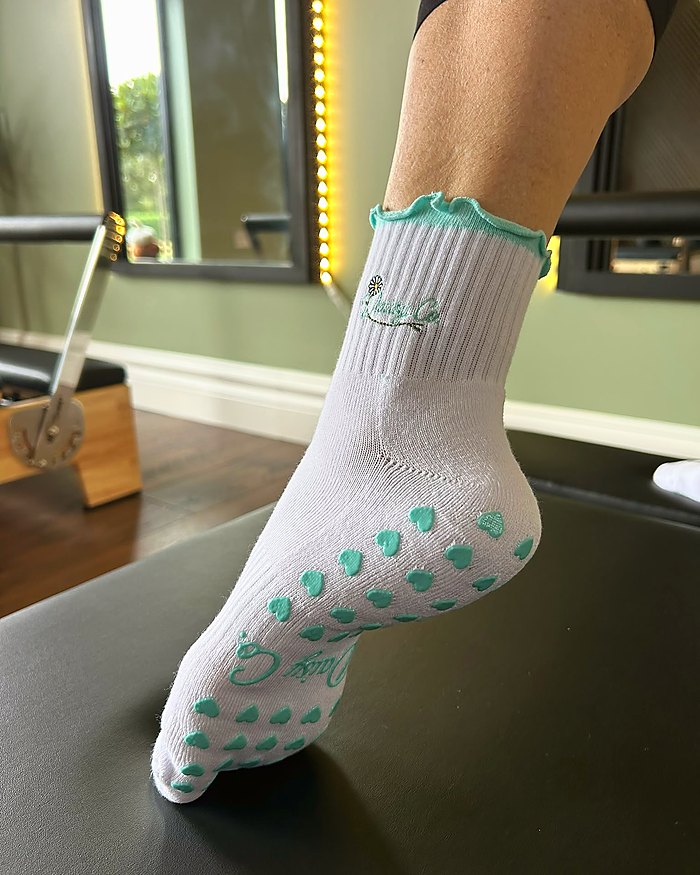 Sea Mist Pilates grip socks, the silicone heart grip sole in use