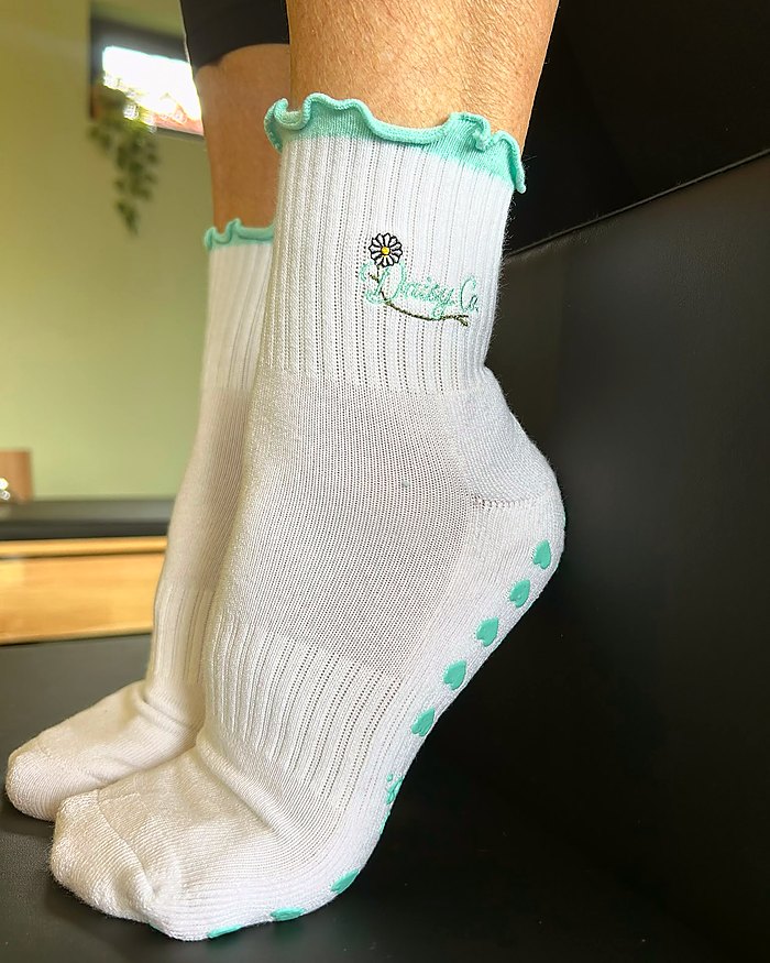 Sea Mist Pilates grip socks during a reformer class