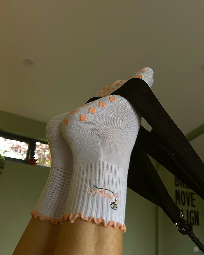 Bare Muse Pilates grip socks during a reformer class