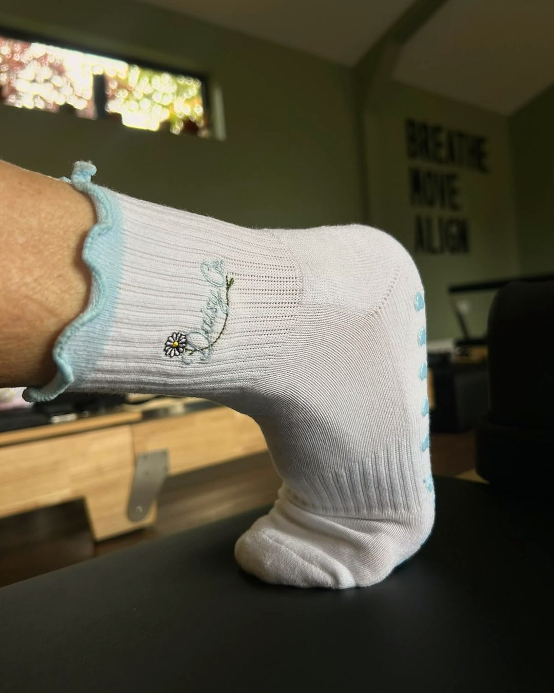 Bluebell grip socks on a reformer carriage
