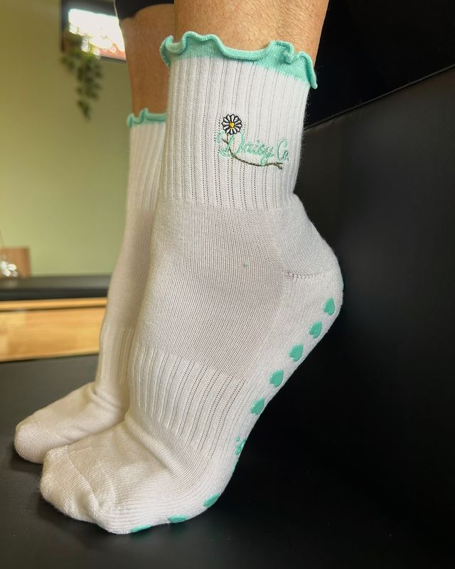 Sea Mist grip socks on a reformer carriage